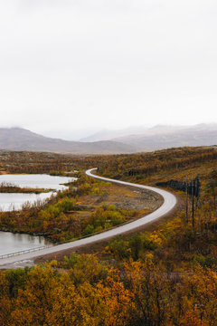 A curved road with mountains in the distance