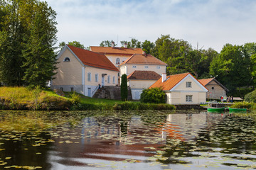 Fototapeta na wymiar An old manor Vihula in Estonia, Lahemaa park. Beautiful summer landscape with pond