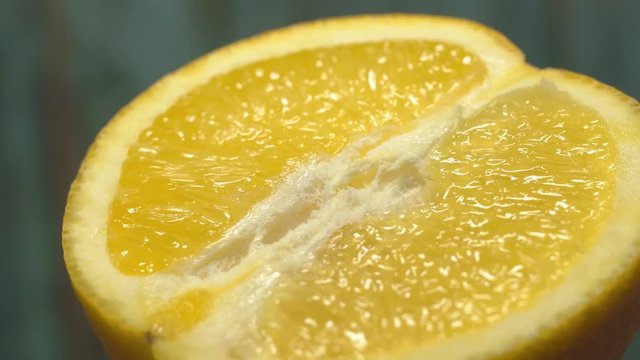 half orange 360 degree torning on a wooden background, tasty healthy food