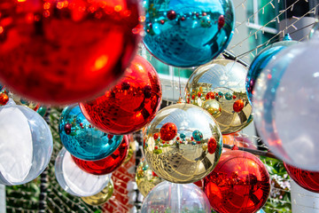 Christmas balls decoration with twinkling light and ornament on fir over colorful bokeh with festive. Shiny xmas glass baubles ball background. Merry Christmas and Happy New Year.