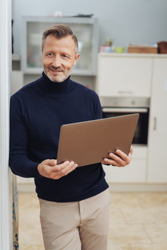 Man with tablet pc, standing at home