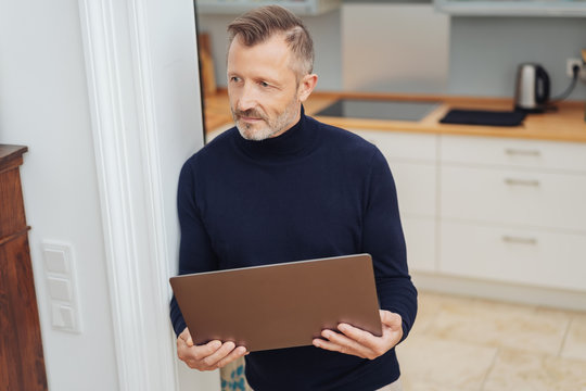 Man with big tablet, standing at home