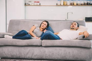 A husband and wife watch TV