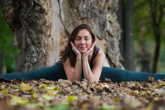 young woman doing yoga outdoors