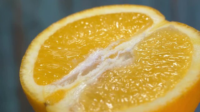 half orange 360 degree torning on a wooden background, tasty healthy food