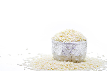 Pile of glutinous rice on silver bowl isolated on white background.