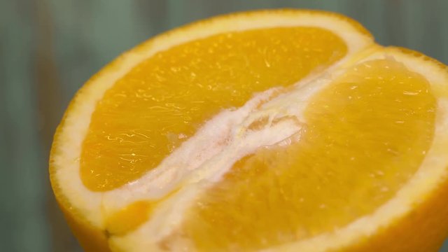 half orange 360 degree torning on a wooden background, tasty healthy food