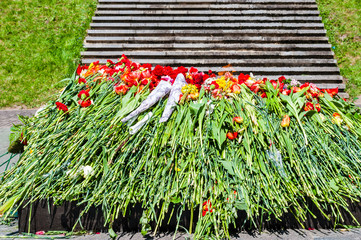 Bunch of flowers laying down near the eternal flame monument on military cemetery in honor of the day of victory in the world war two on the ninth of May each year in Vilnius