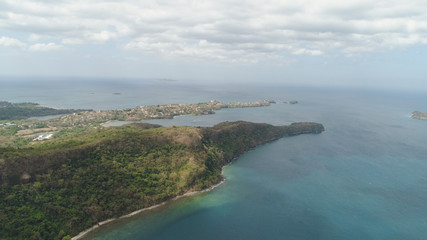 Aerial view of coast with beach, hotels. Philippines, Luzon. Coast ocean with tropical beach, turquoise water. Tropical landscape in Asia.