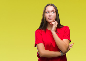 Young beautiful caucasian woman over isolated background with hand on chin thinking about question, pensive expression. Smiling with thoughtful face. Doubt concept.