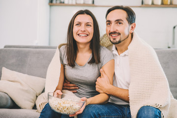 A woman and husband wandering the TV