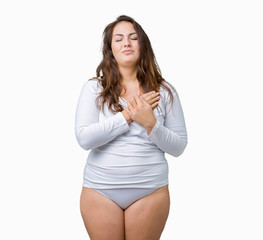 Beautiful plus size young overwight woman wearing white underwear over isolated background smiling with hands on chest with closed eyes and grateful gesture on face. Health concept.