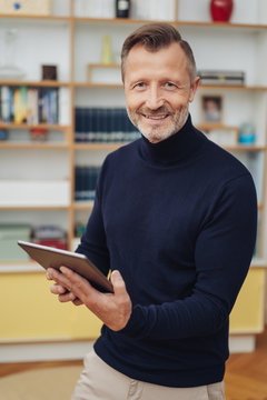Man with tablet pc smiling at camera