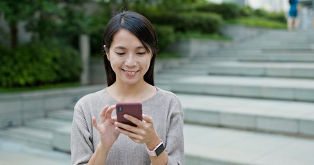 Woman work on smart phone in city