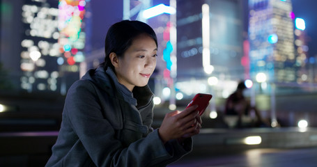 Woman use of mobile phone online at night