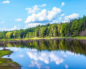 Obraz premium clouds, sky, trees reflected in a still country pond