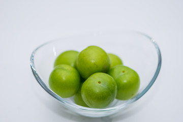 The small turkish green plums in the glass bowl
