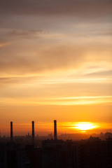 Three chimneys at sunset, city landscape