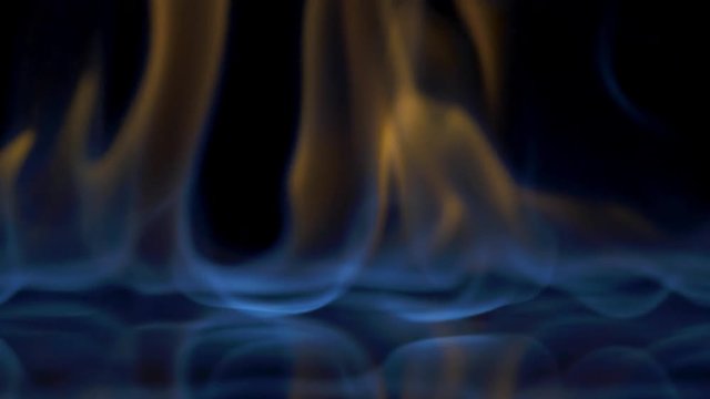 Flames burn on the mirror surface on a black background