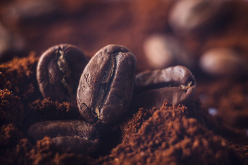 Ground coffee and grains macro shot. Smoke from freshly roasted coffee beans.