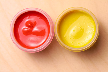  Jars with gouache closeup on wood background
