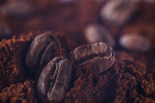 Ground coffee and grains macro shot. Smoke from freshly roasted coffee beans. © Vall_Ben