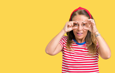 Beautiful middle age woman wearing casual stripes t-shirt over isolated background Trying to open eyes with fingers, sleepy and tired for morning fatigue