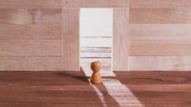 Abstract man in the doorway. Wall of wooden puzzles. Success concept. Pathway of opportunity. Target, achievement, business metaphor.