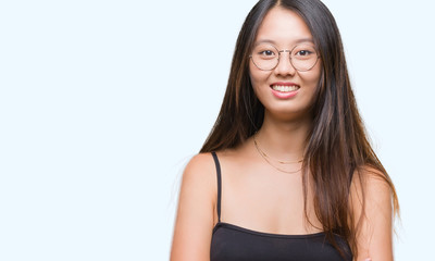 Young asian woman wearing glasses over isolated background happy face smiling with crossed arms looking at the camera. Positive person.