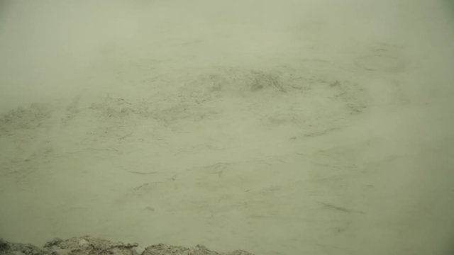 mud volcano Kawah Sikidang, geothermal activity and geysers. plateau Dieng with volcanic activity Indonesia. Famous tourist destination of Sikidang Crater it still generates thick sulfur fumes.