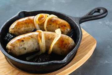 White sausage fried with onions and dried plums.