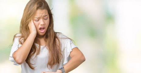 Young beautiful brunette business woman over isolated background Looking at the watch time worried,...