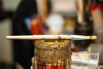 brush on the jar with glue in the workshop