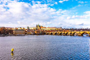 Prague, Czech republic: Look to Charles bridge and Prague castle in far. Sunny winter day near the Vltava river. Panorama view of Prague city, cityscape with Prague castle. Czech capital