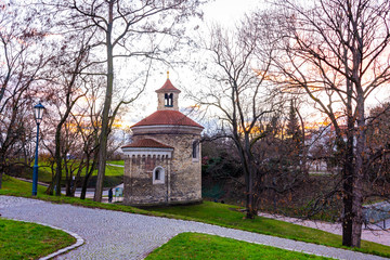 Prague, Czech republic: Panorama of Vysehrad basilica during the sunset. Orange clouds above the ancient church in czech capital