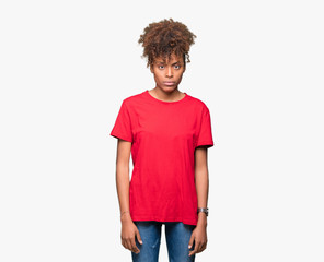 Beautiful young african american woman over isolated background skeptic and nervous, frowning upset...