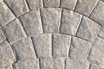 The road is paved with gray sets. Road surface.