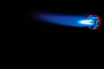 Blue flame with a manual gas burner with a black background