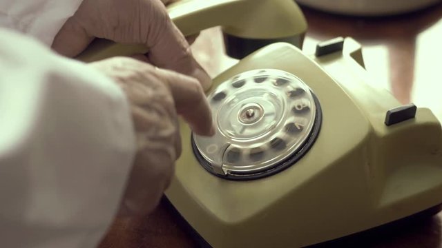 Doctor Dialing A Number On A Vintage Retro Rotary Phone