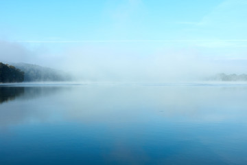 Naklejka na ściany i meble Morning fog on the lake on a summer day