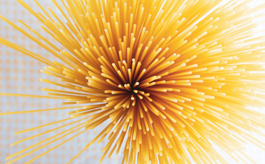 Spaghetti on Yellow background. Long spaghetti. Raw spaghetti wallpaper. Food background concept. Top view. Blank for design..