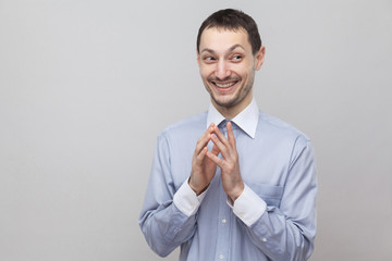 Portrait of funny toothy smiley handsome bristle businessman in classic light blue shirt standing...