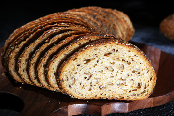 freshly baked bread on wooden board. cutted bread