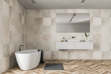 Beige tile bathroom interior, tub and sink