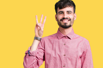 Young handsome man wearing pink shirt over isolated background showing and pointing up with fingers number three while smiling confident and happy.