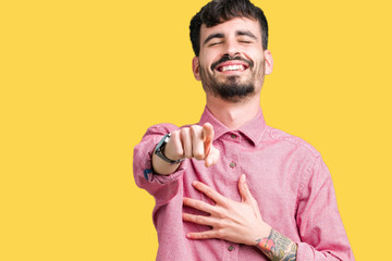 Young handsome man wearing pink shirt over isolated background Laughing of you, pointing to the camera with finger hand over chest, shame expression