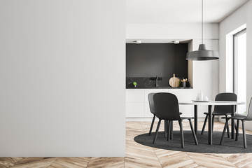 White and black kitchen with table, wall