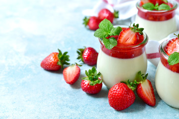 Vanilla panna cotta with strawberry jelly in a vintage jar, traditional italian dessert.