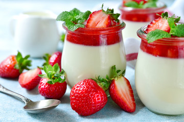 Vanilla panna cotta with strawberry jelly in a vintage jar, traditional italian dessert. - obrazy, fototapety, plakaty