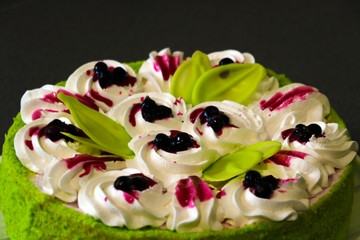 Cake with coconut flakes and currants in cream, view from the top.
